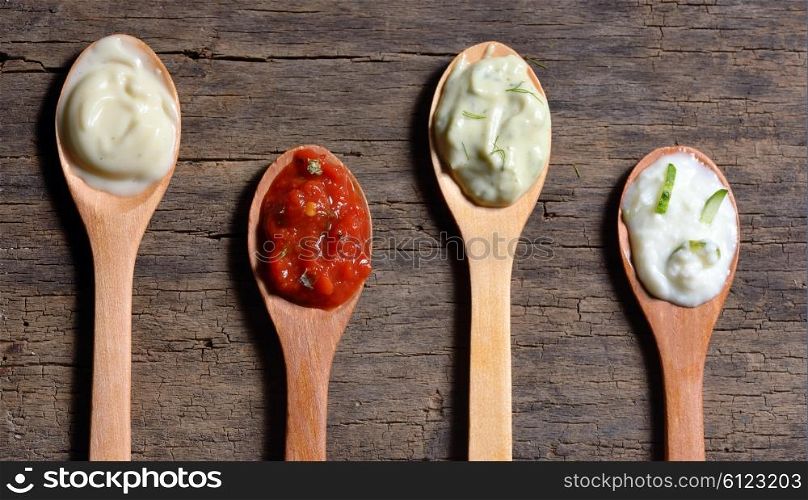 Different types of condiments on spoons