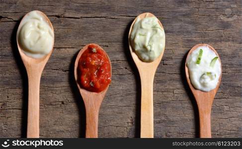 Different types of condiments on spoons