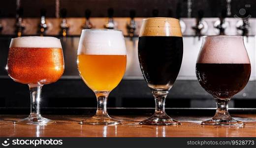 different types of craft beer in glasses on table in pub interior