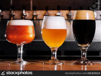 different types of craft beer in glasses on table in pub interior in daylight