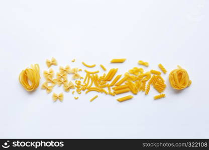 Different types of dry pasta on white background