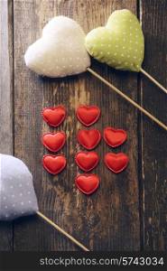 different types of fabric hearts on wooden background. Valentine&#39;s day