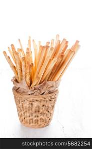 Different types of grissini breadsticks in a basket