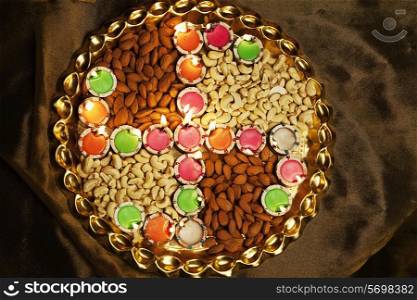 Different types of nuts with diyas