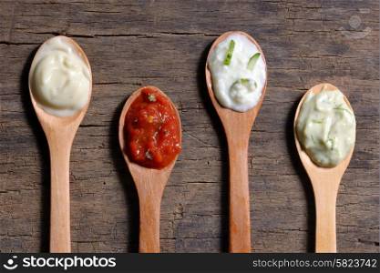 different types of sauces in spoons