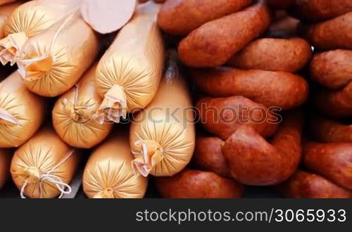 different types of sausages on counter, panorama left to right