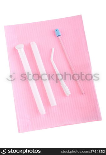 different types of surgical aspirators (single use) on a pink bib (isolated on white background)