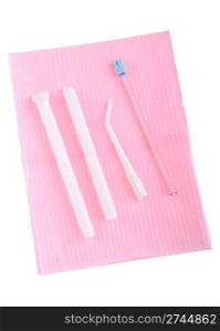 different types of surgical aspirators (single use) on a pink bib (isolated on white background)