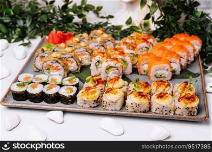 different types of sushi rolls on big plate