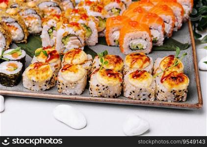 different types of sushi rolls on big plate