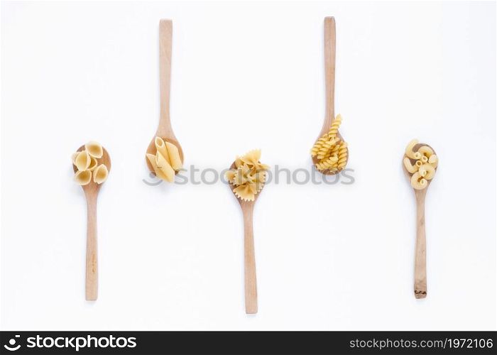 different types raw italian pasta wooden spoon white surface. High resolution photo. different types raw italian pasta wooden spoon white surface. High quality photo