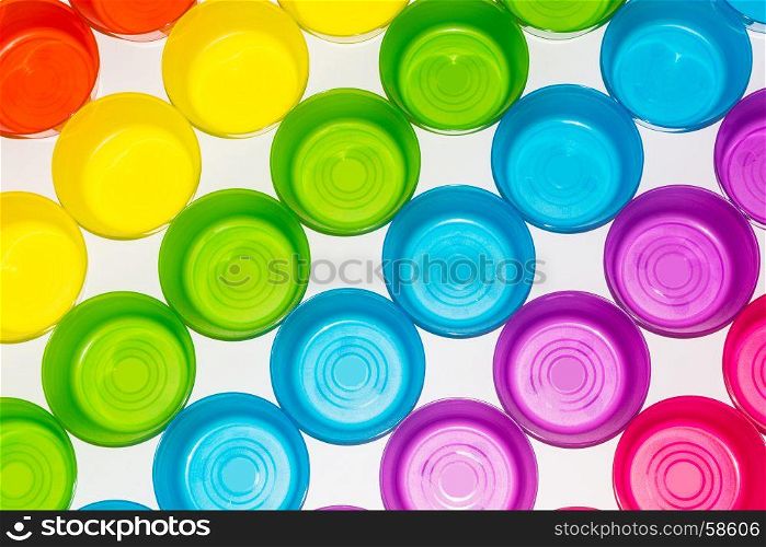 Differently colored colorful glasses on a white background. Taken from above.