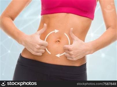 digestion, diet and people concept - close up of female with arrows on abdomen and hands showing thumbs up. close up of woman showing tummy and thumbs up