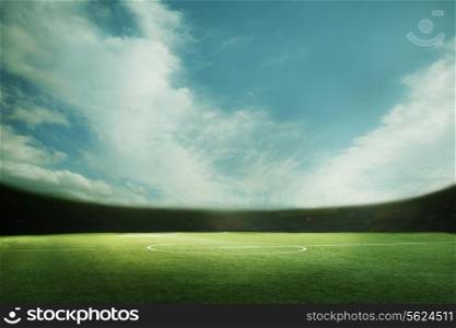 Digital composite of soccer field and blue sky
