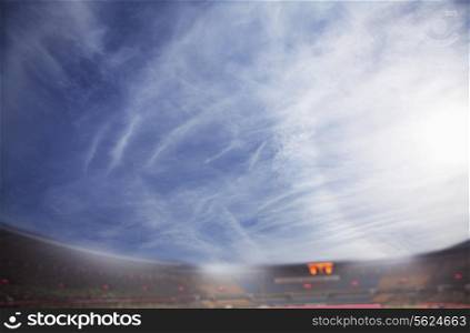 Digital composite of soccer field and blue sky