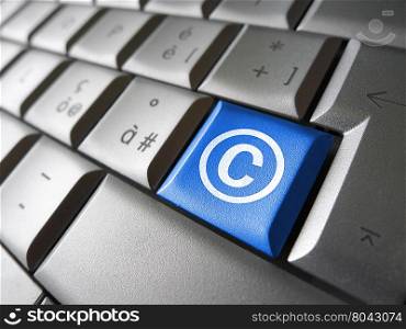 Digital copyright web content and Internet concept with copyright symbol and icon on a blue laptop computer key for blog, website and online business.