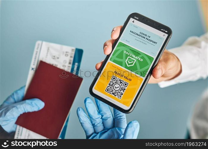 Digital covid certificate. Covid vaccination digital pass. Woman passenger holding digital medical pass on her mobile phone, passport and airplane ticket. Traveler showing digital covid test result as medical pass for travel during covid-19 pandemic