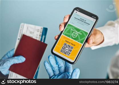 Digital covid certificate. Covid vaccination digital pass. Woman passenger holding digital medical pass on her mobile phone, passport and airplane ticket. Traveler showing digital covid test result as medical pass for travel during covid-19 pandemic