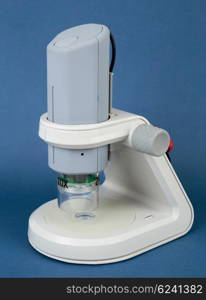 Digital educational microscope on blue background