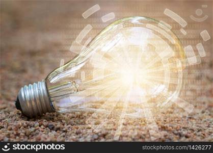 Digital light bulb / illuminated in the sand