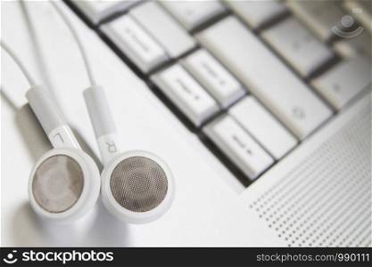 Digital Music Concept With Earphones On Laptop Keyboard