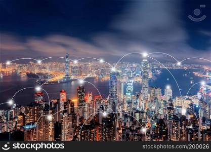 Digital network connection lines of Hong Kong Downtown. Financial district and business centers in smart city in technology concept. Skyscraper and high-rise buildings. Aerial view at night