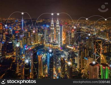 Digital network connection lines of Kuala Lumpur Downtown, Malaysia. Financial district and business centers in smart city in technology concept. Skyscraper and high-rise buildings at night