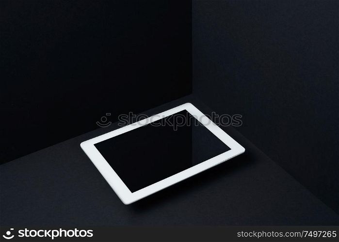 Digital pad floating on mockup three dimensional black background