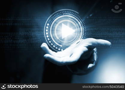 Digital play icon. Businesswoman with media player button in palm