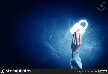 Digital safety blue concept. Hand of businessman on dark background with security glowing sign