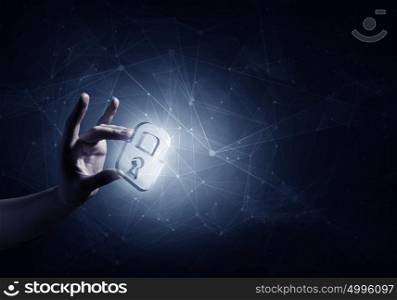 Digital safety blue concept. Hand of businessman on dark background with security glowing sign