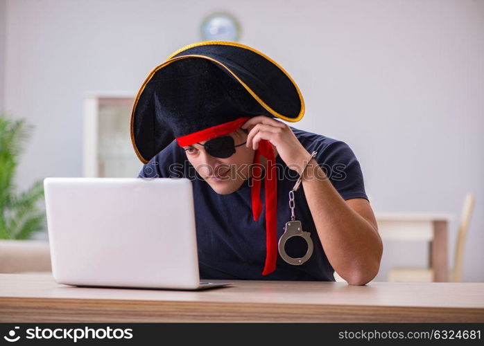 Digital security concept with pirate at computer