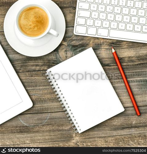 Digital tablet pc, keyboard, notebook and cup of coffee on wooden table. Flat lay