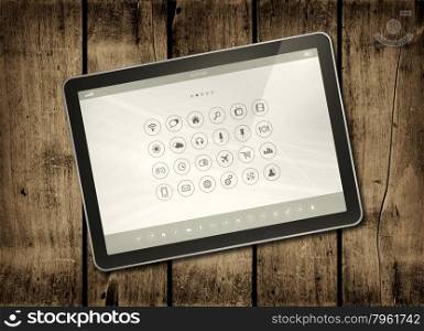 Digital tablet PC with desktop icons on a dark wood table - horizontal office mockup. Digital tablet PC on a dark wood table