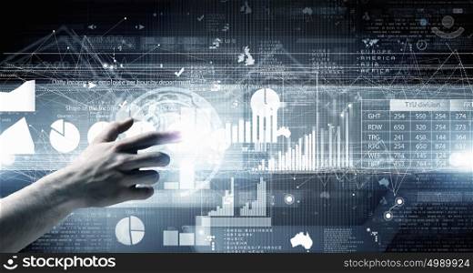 Digital technlogies in use. Close up of businessman touching virtual panel with finger