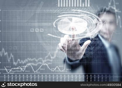 Digital technlogies in use. Portrait of businessman touching virtual panel with finger
