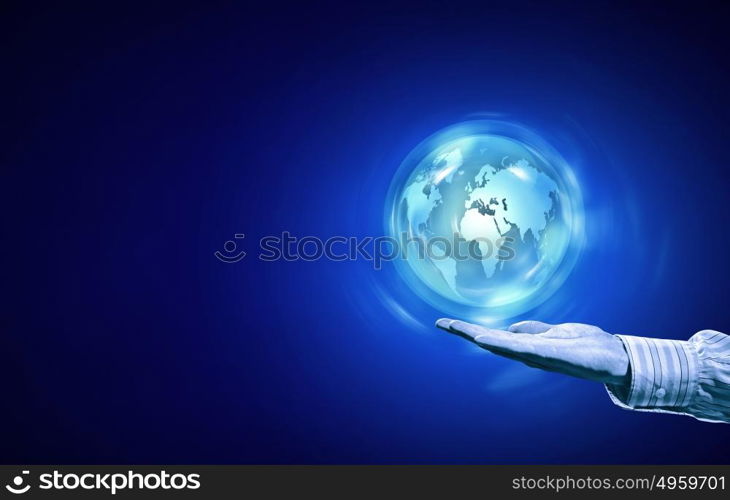 Digital world. Person hand and digital Earth planet on palm on blue background