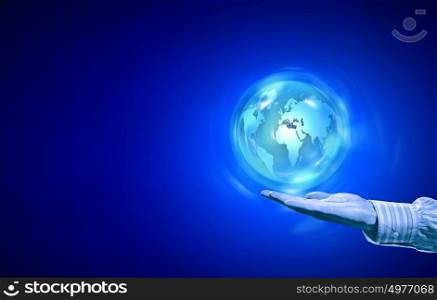 Digital world. Person hand and digital Earth planet on palm on blue background