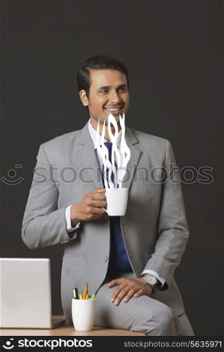 Digitally generated image of businessman having coffee in office