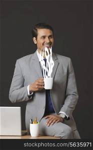 Digitally generated image of businessman having coffee in office