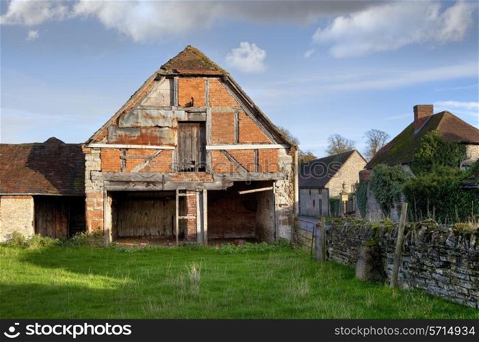 Dilapidated half-hipped Warwickshire barn, England.