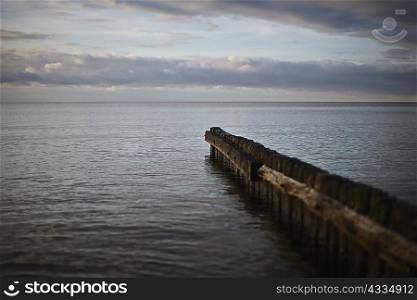 Dilapidated pier stretching into bay