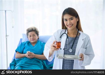 Diligent doctor or nurse making sure her patient taking medication
