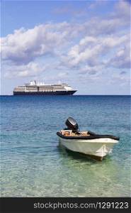 Dinghy with outboard motor and cruise ship, Dravuni Island, Fiji, South Pacific
