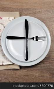 Dining etiquette - I still eat, ready for second plate. Fork and knife signals with location of cutlery set