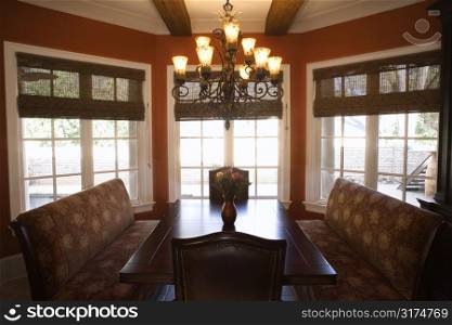 Dining room with table and chairs in affluent home.
