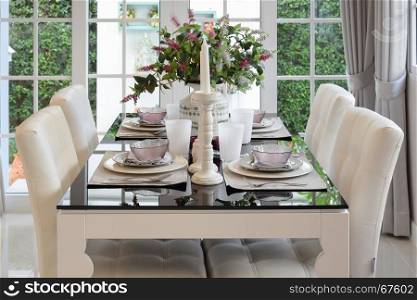 dining table and comfortable chairs in vintage style with elegant table setting