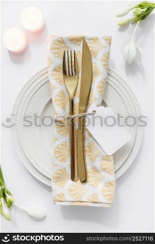 dining table setting with folded napkin candles white background