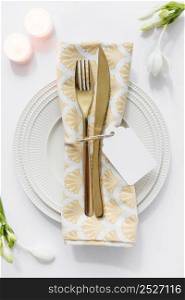 dining table setting with folded napkin candles white background