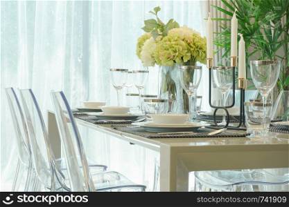 Dining table with vase of flower in dining room
